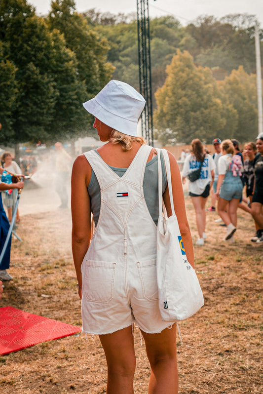 a person wearing a white hat and white shorts