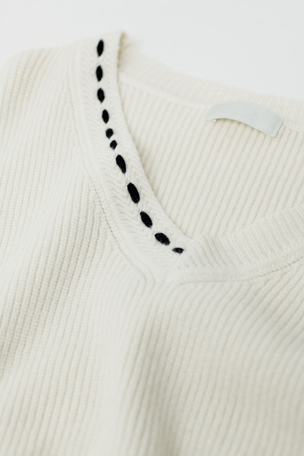 V neck sweater with black embroidered detail