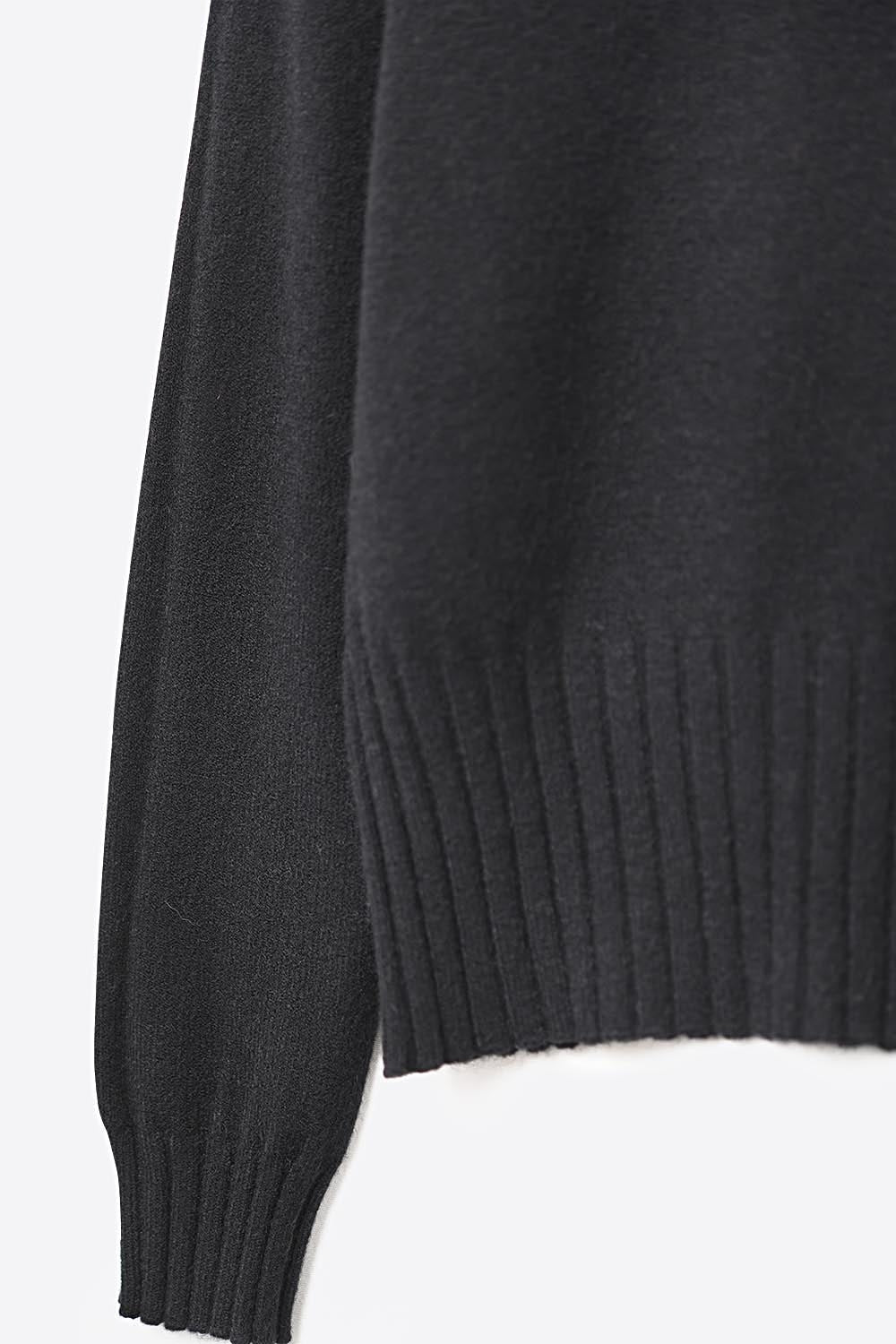Black soft knit sweater with ribbed cuffs and neck
