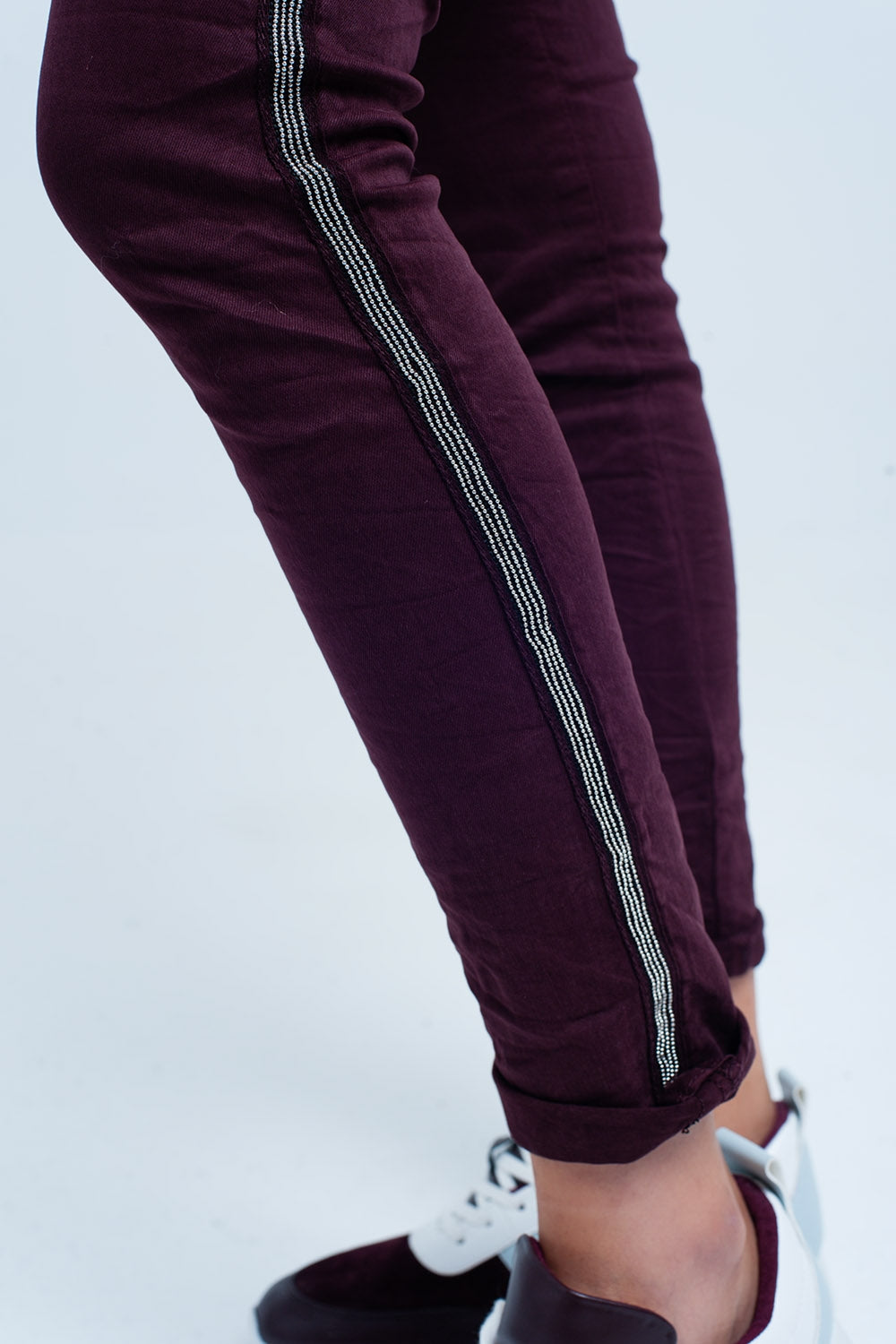 Maroon skinny jeans with metal side stripe