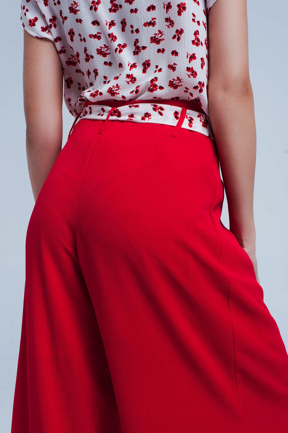 Red pants with floral belt