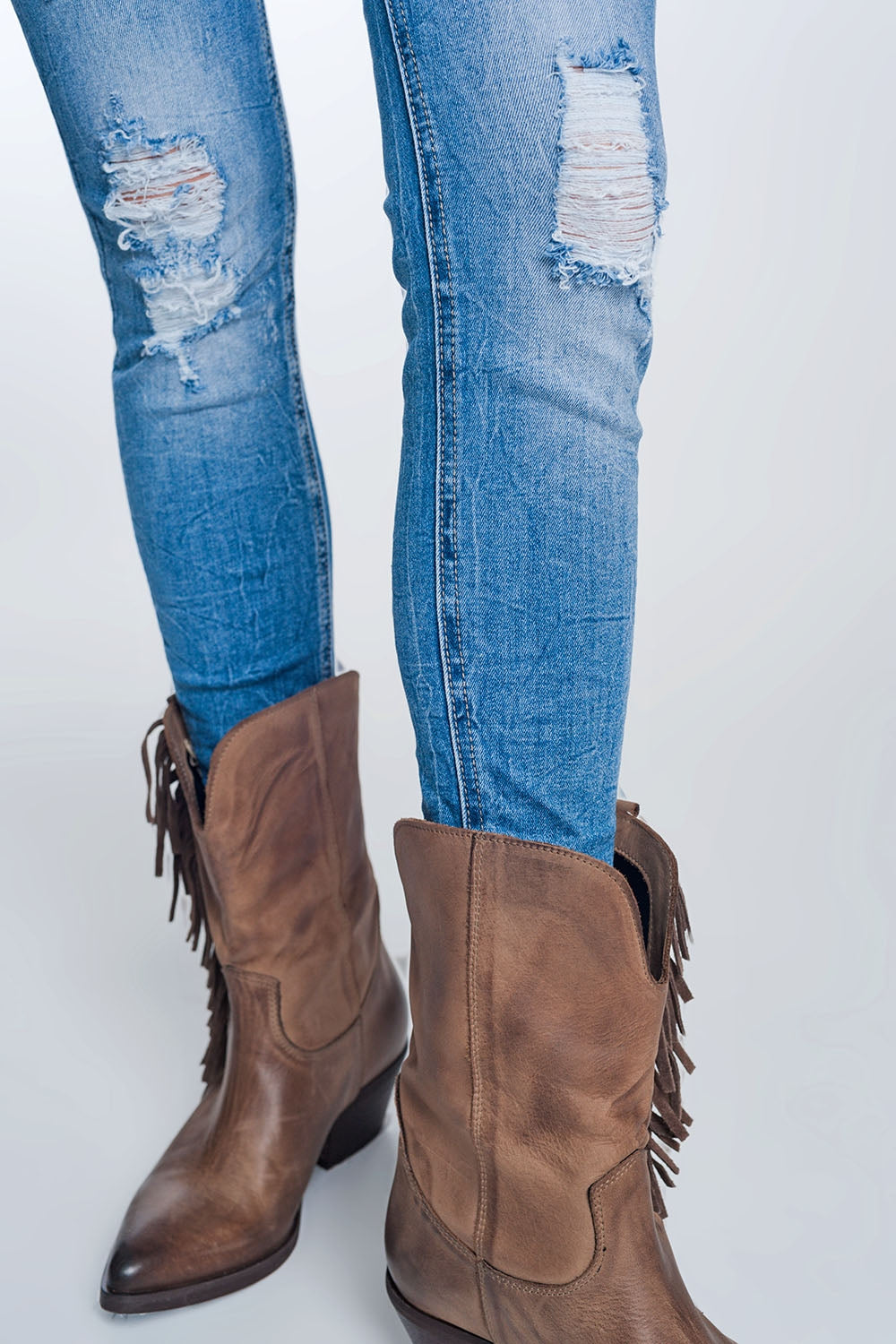 super skinny jeans in vintage mid wash blue with heavy rips