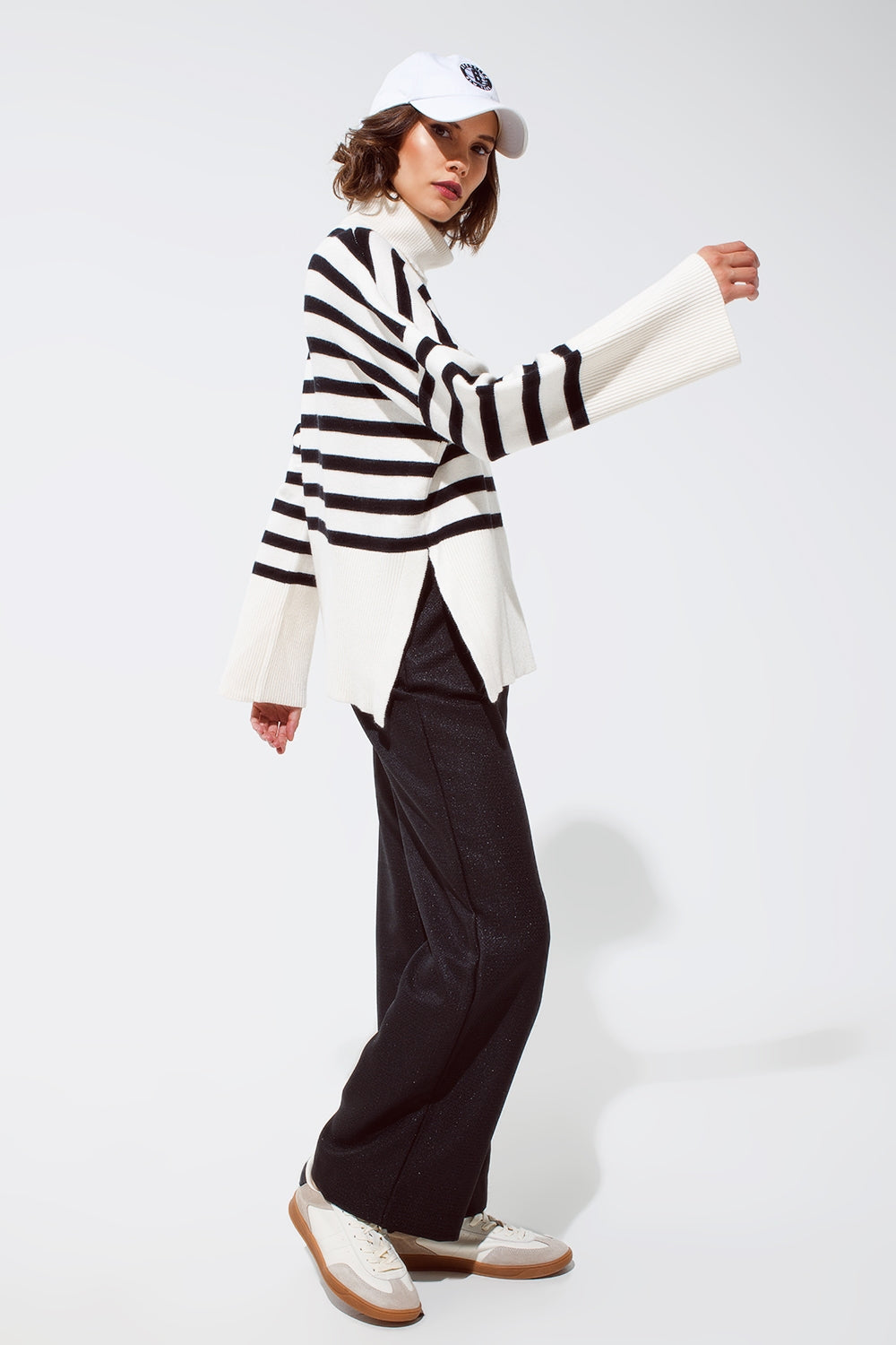 White oversized trutleneck sweater with black stripes and splits on the side