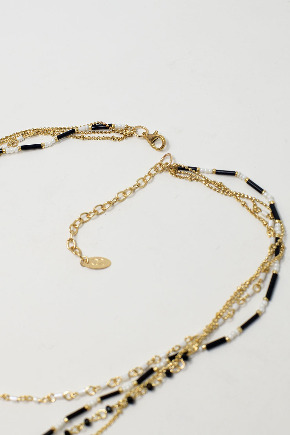 Gold 4 in 1 necklace with black and white beads