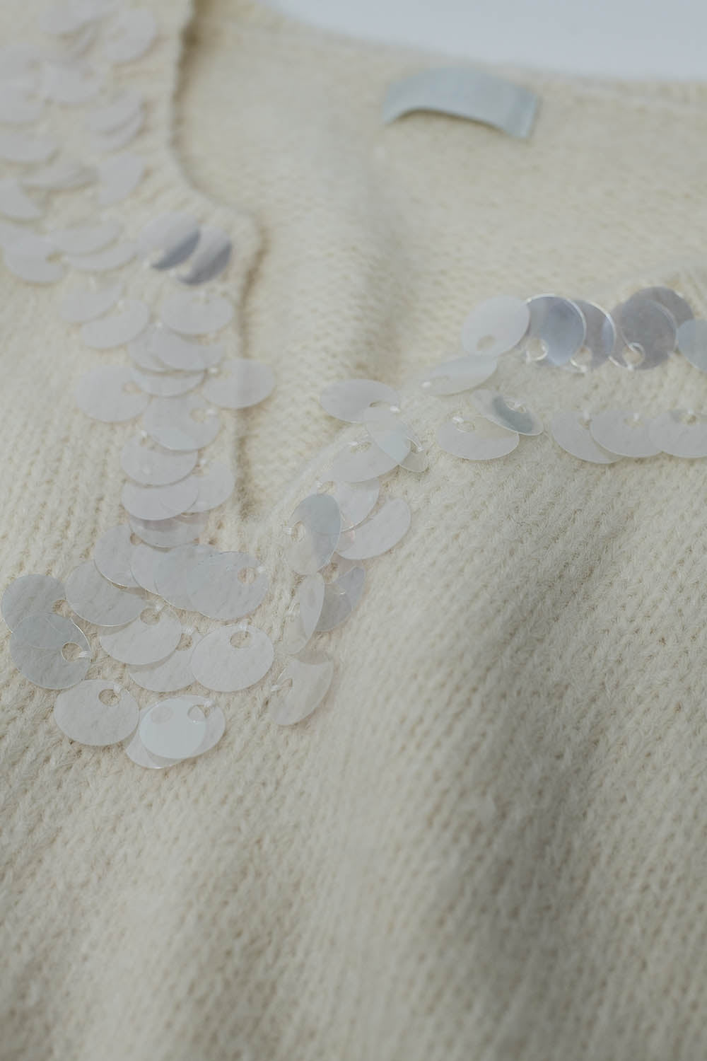 Cream V-neck sweater with sequin detail