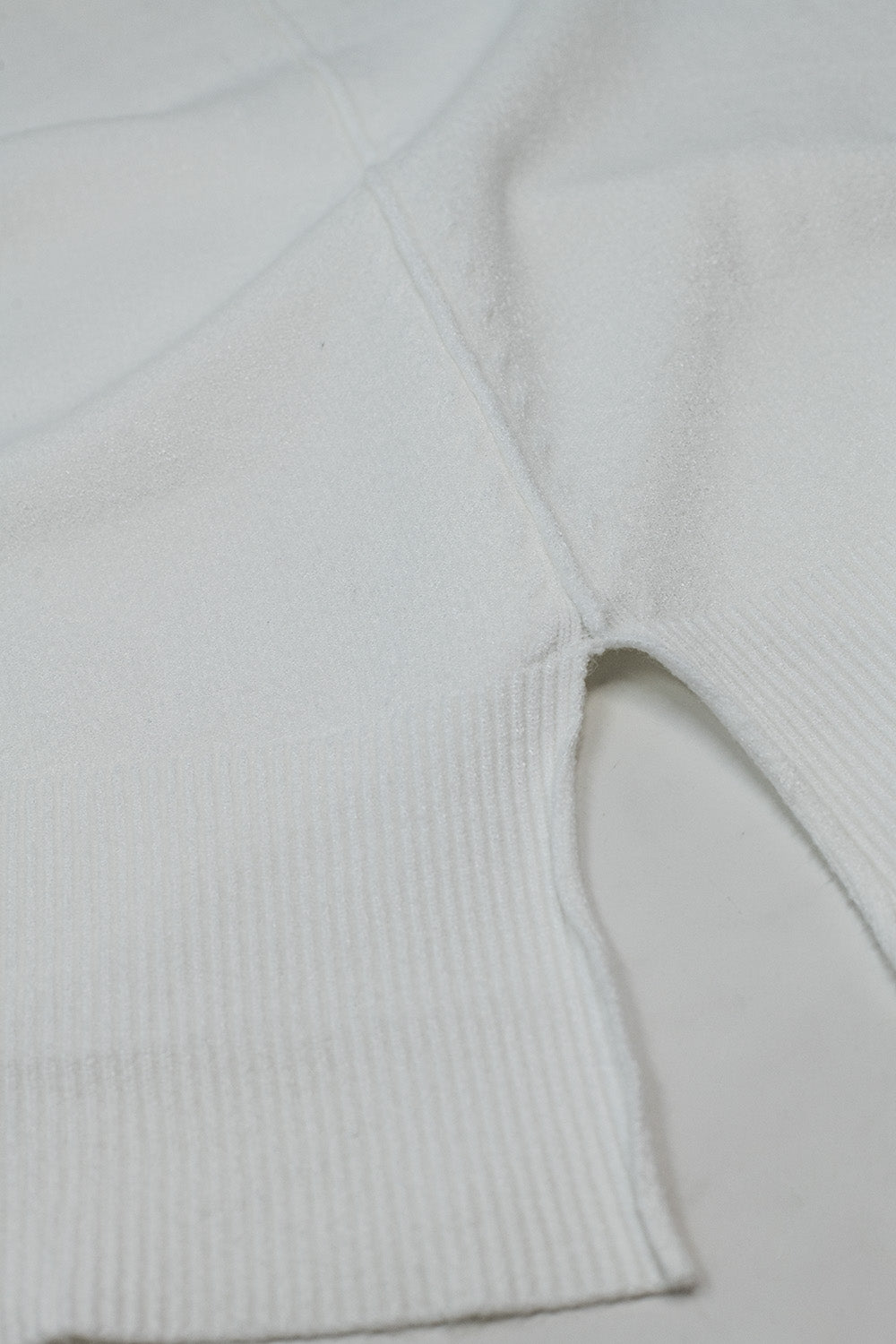 Loose white sweater with open back detail