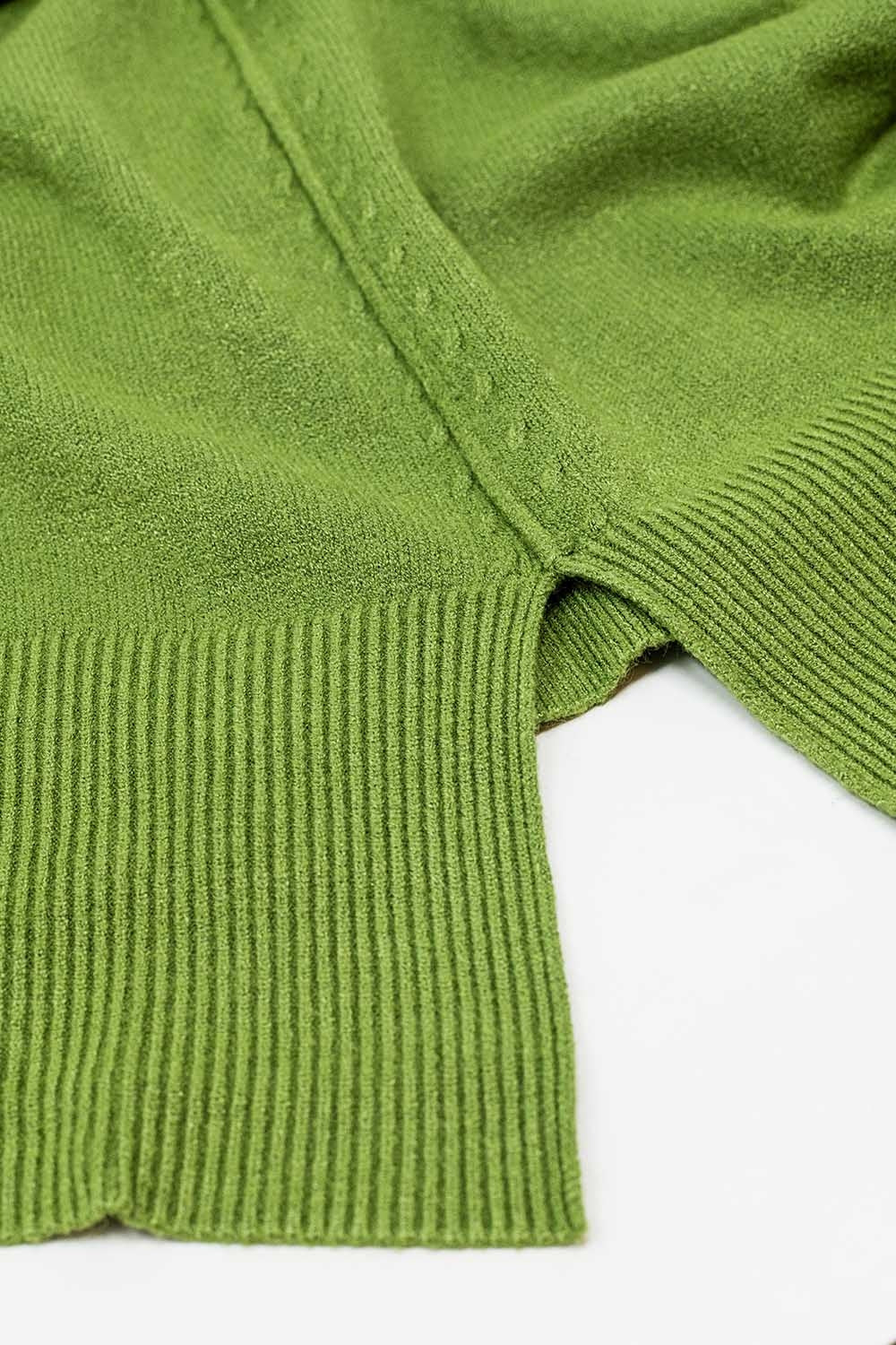 Loose green sweater with opening in the back