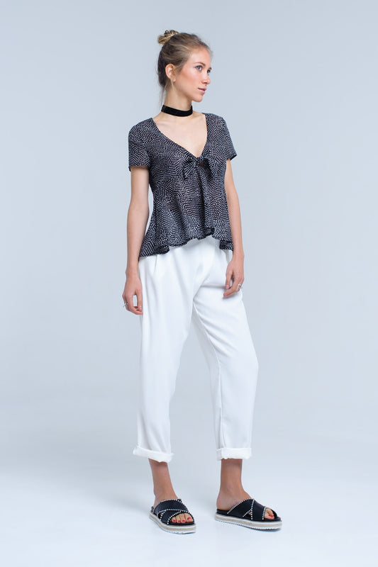 Black polka dot top with ruffle hem - Tops