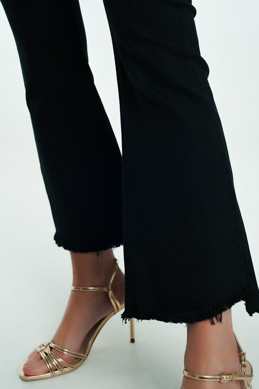 High rise raw hem flared jeans in black - Jeans