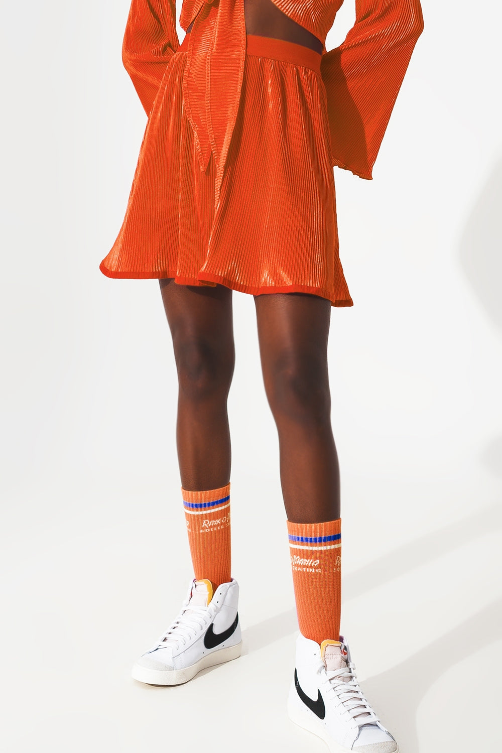 Pleated short skirt in orange - Skirts