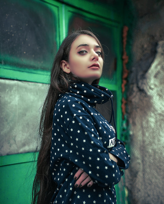 a woman standing in front of a green door