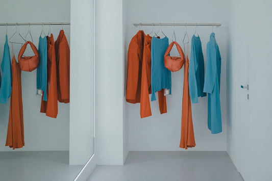 A room that has a bunch of clothes hanging on a rack