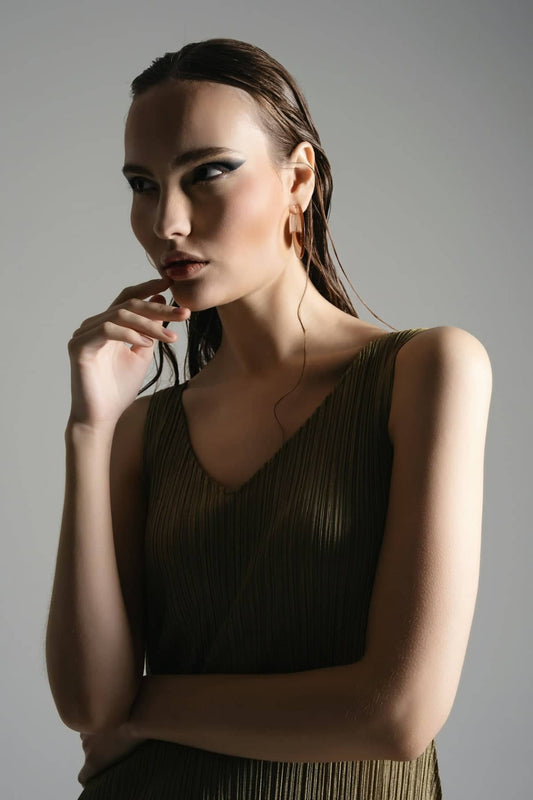 A thoughtful woman poses for a fashion shot.