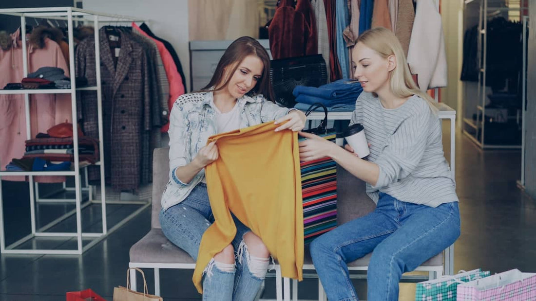 Two women are shopping for clothes together.