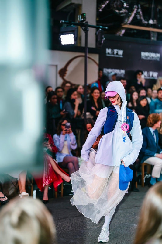 Fashion model walks runway in stylish outfit
