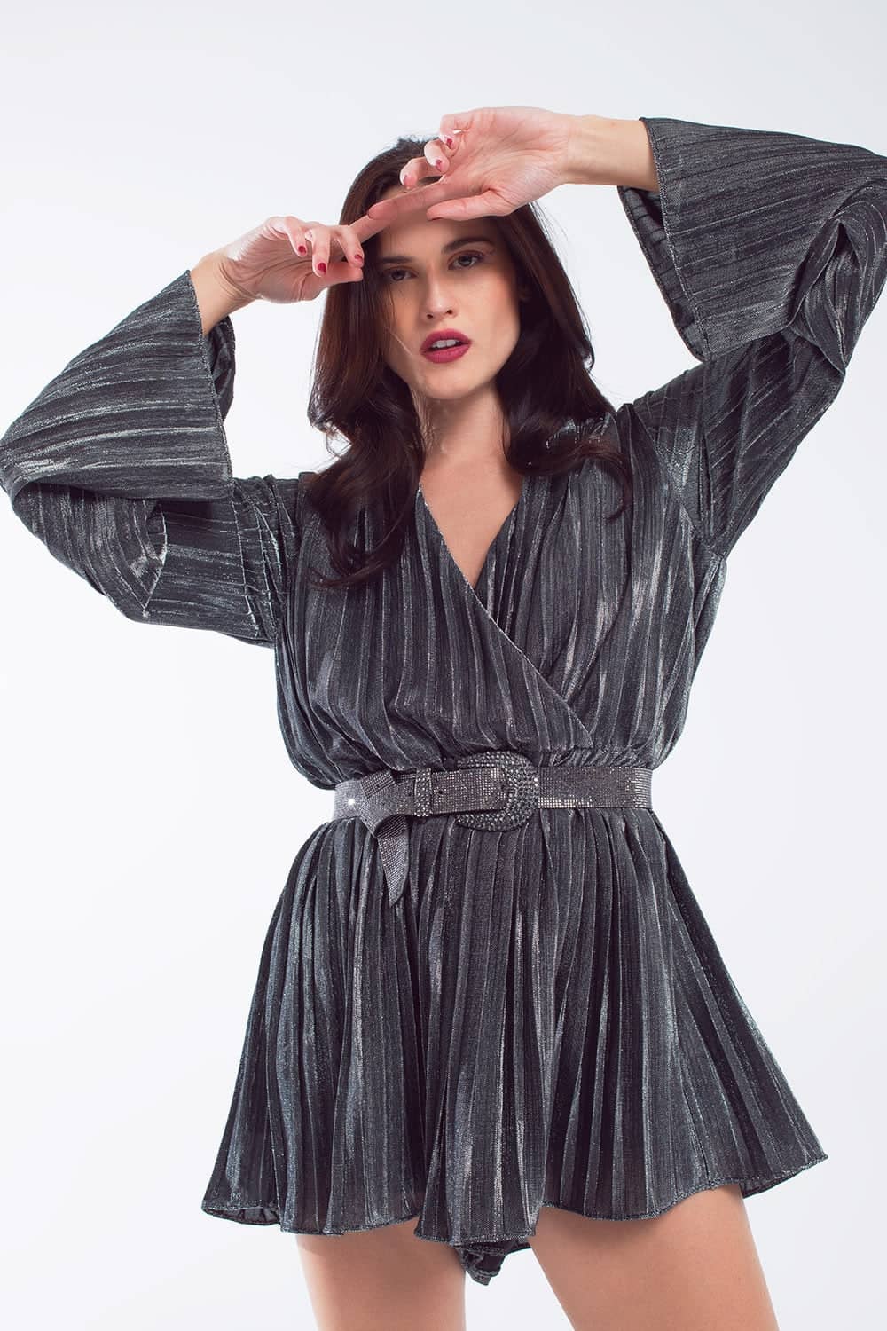 Woman modelling a grey pleated playsuit with wide sleeves and belt from women's jumpsuits and playsuits collection