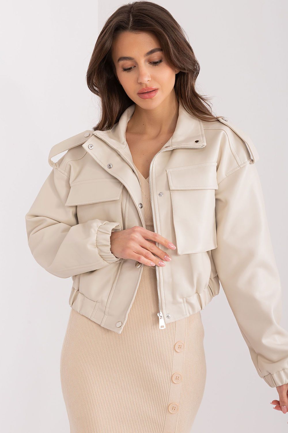 Woman wearing a white and black varsity jacket perfect for shop women's statement outerwear collection