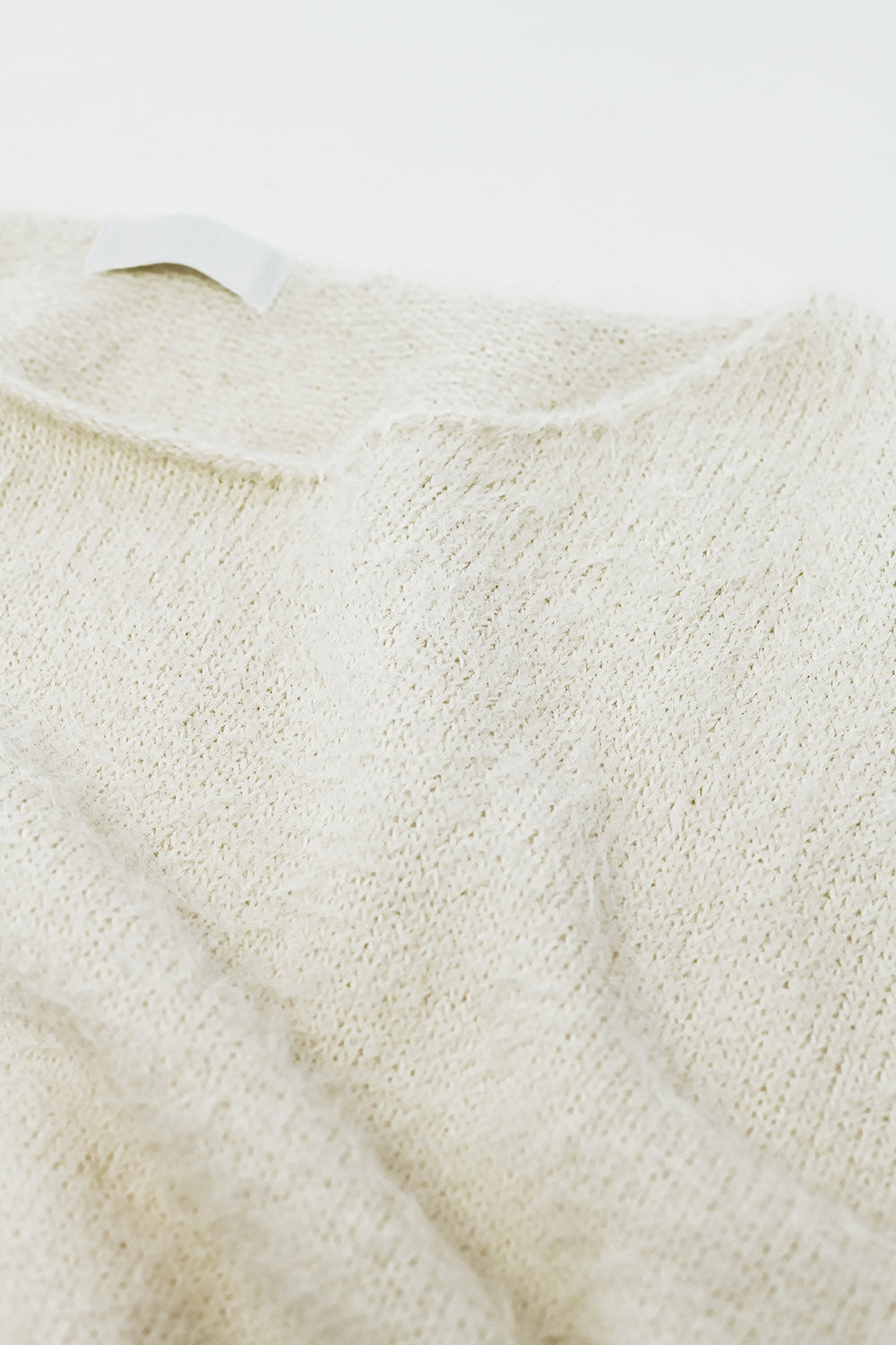 cropped fluffy sweater in cream fitted at the waist