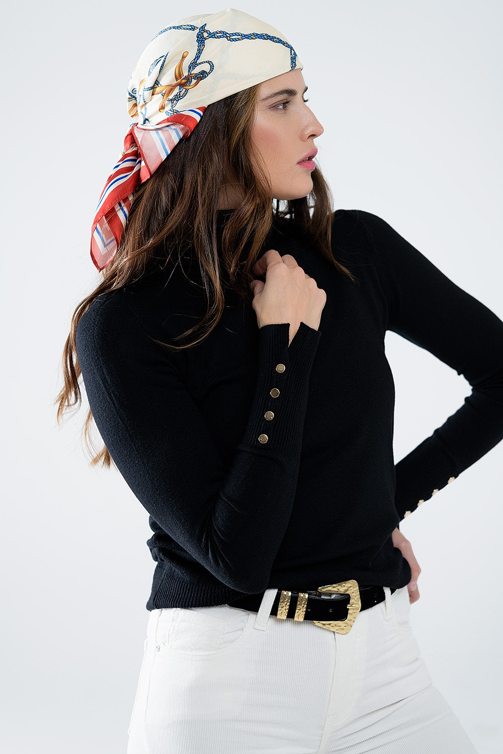 Black turtleneck sweater with gold buttons on the cuff
