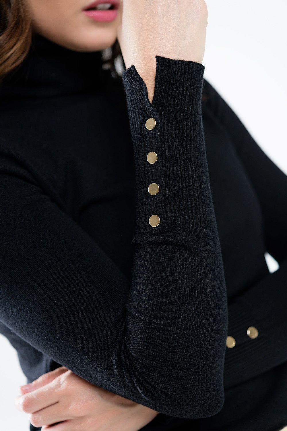 Black turtleneck sweater with gold buttons on the cuff