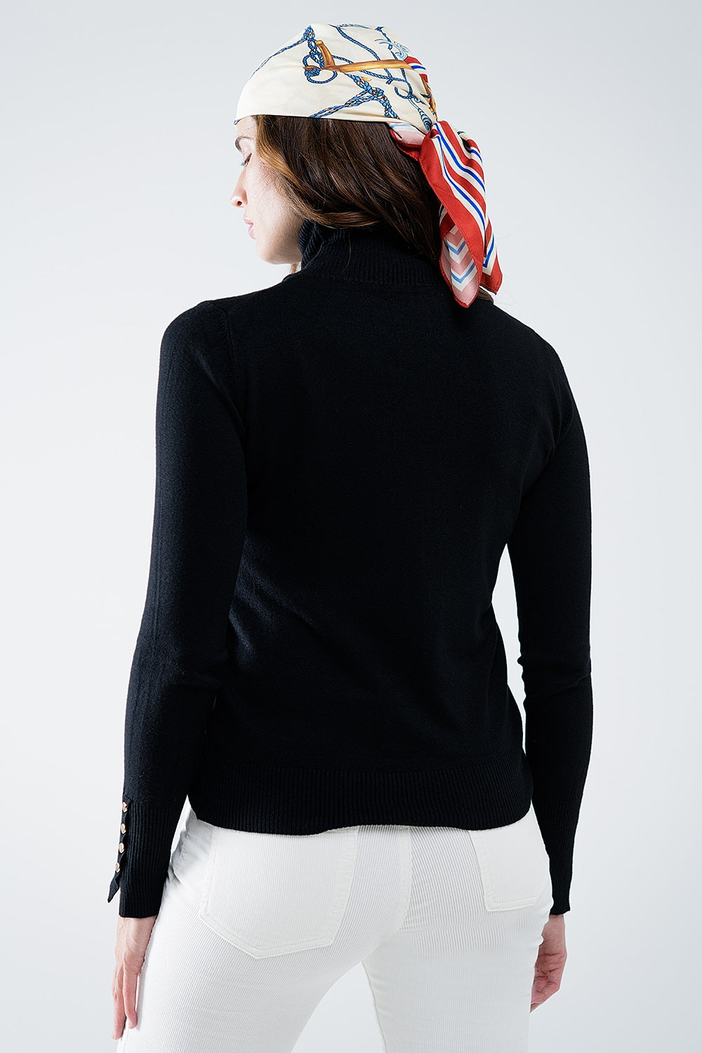 Black turtleneck sweater with gold buttons on the cuff