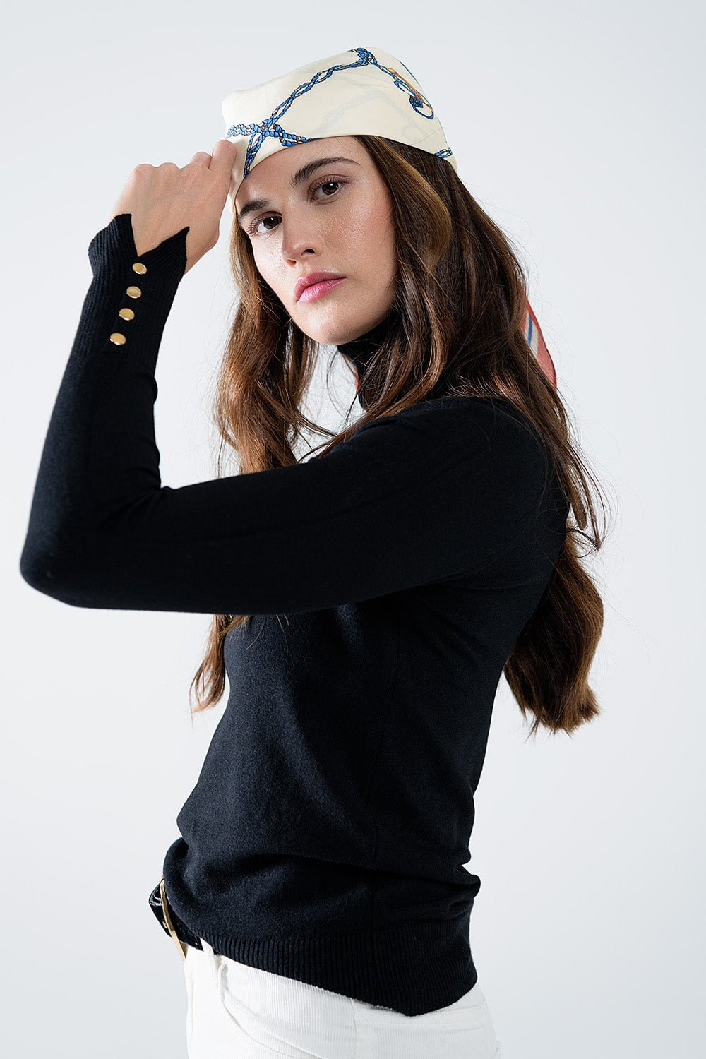 Black turtleneck sweater with gold buttons on the cuff