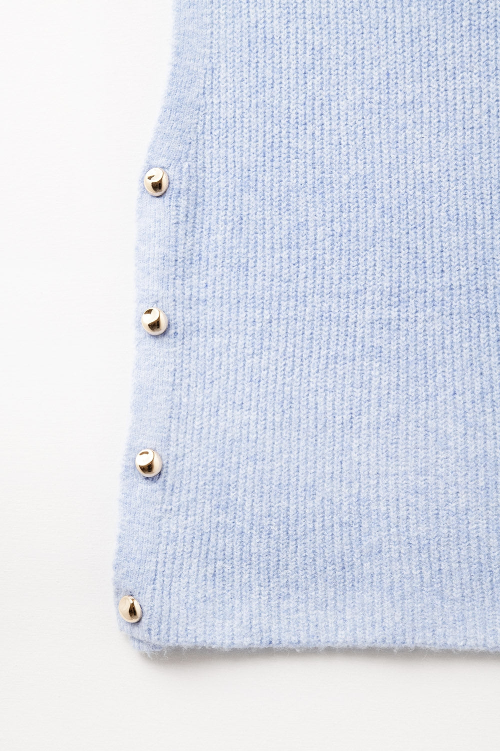 Blue sleeveless sweater with gold buttons on side