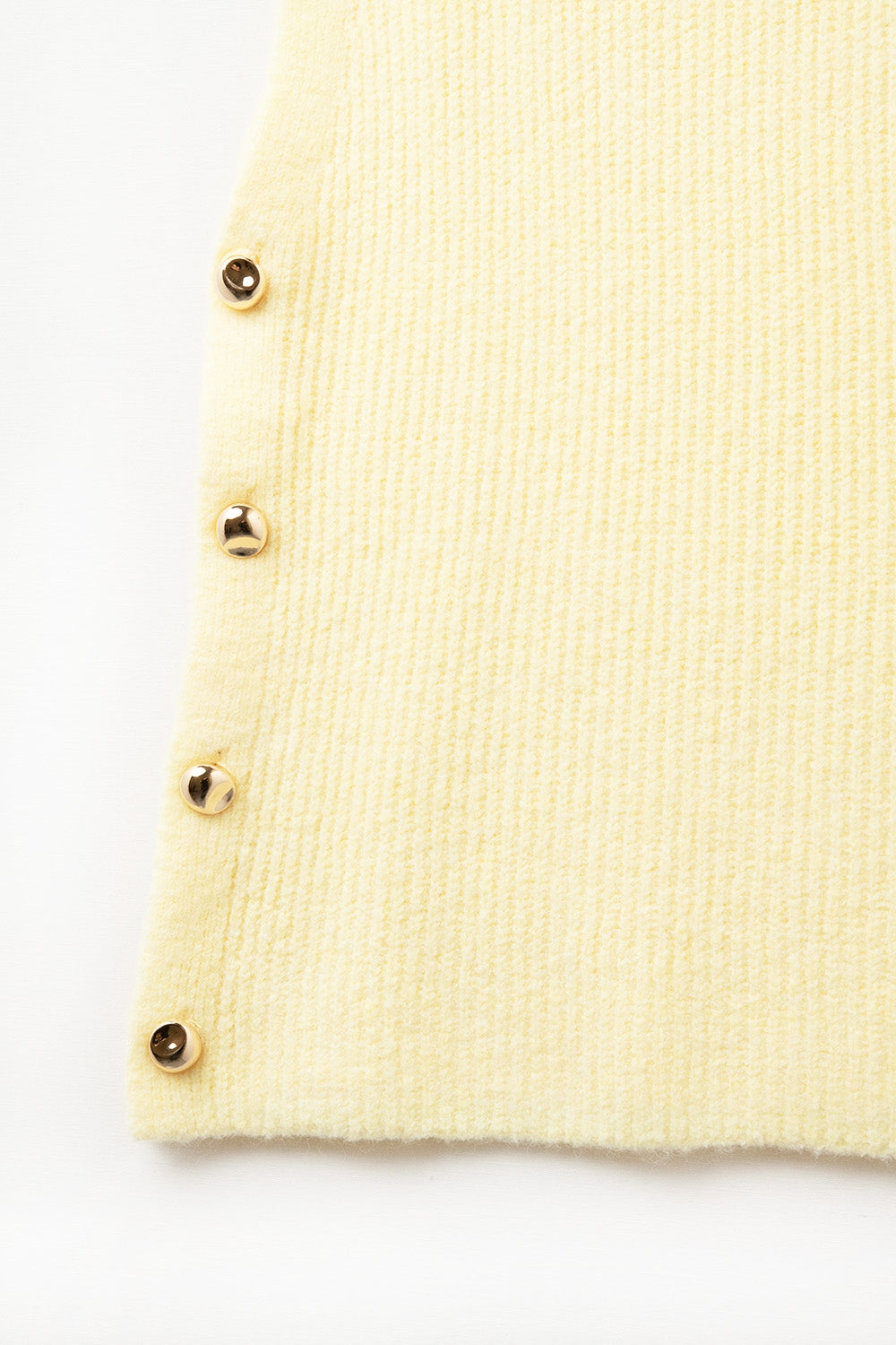 Yellow sleeveless sweater with gold buttons on side