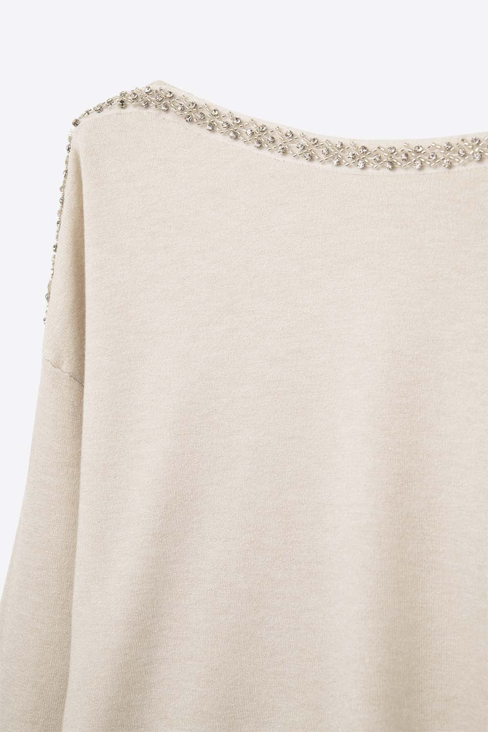 cream fine knit sweater with a boat neck and rhinestone detail