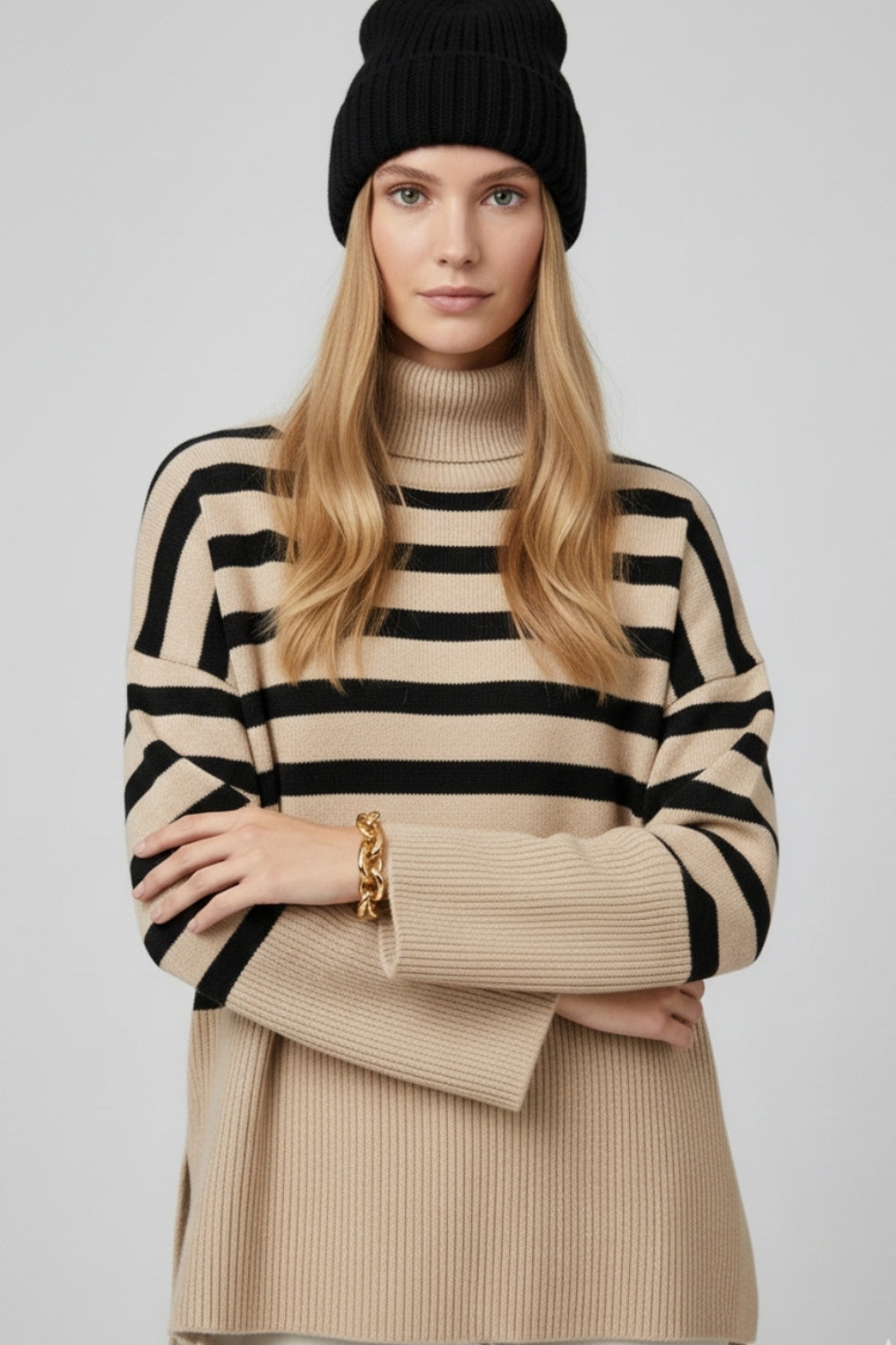 Beige oversized turtleneck sweater with black stripes and splits on the side