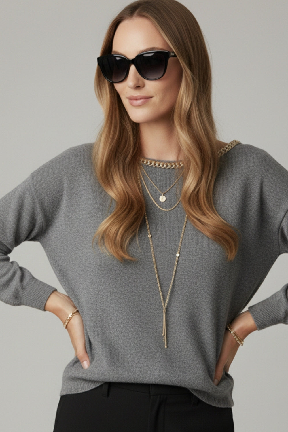 grey fine knit sweater with a boat neck and rhinestone detail