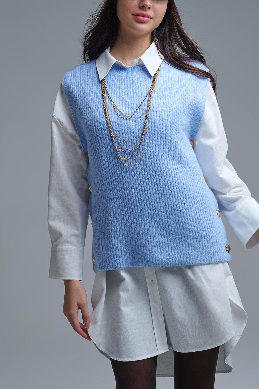 Blue sleeveless sweater with gold buttons on side