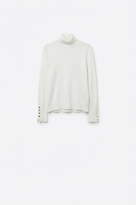 White turtleneck sweater with gold buttons on the cuff