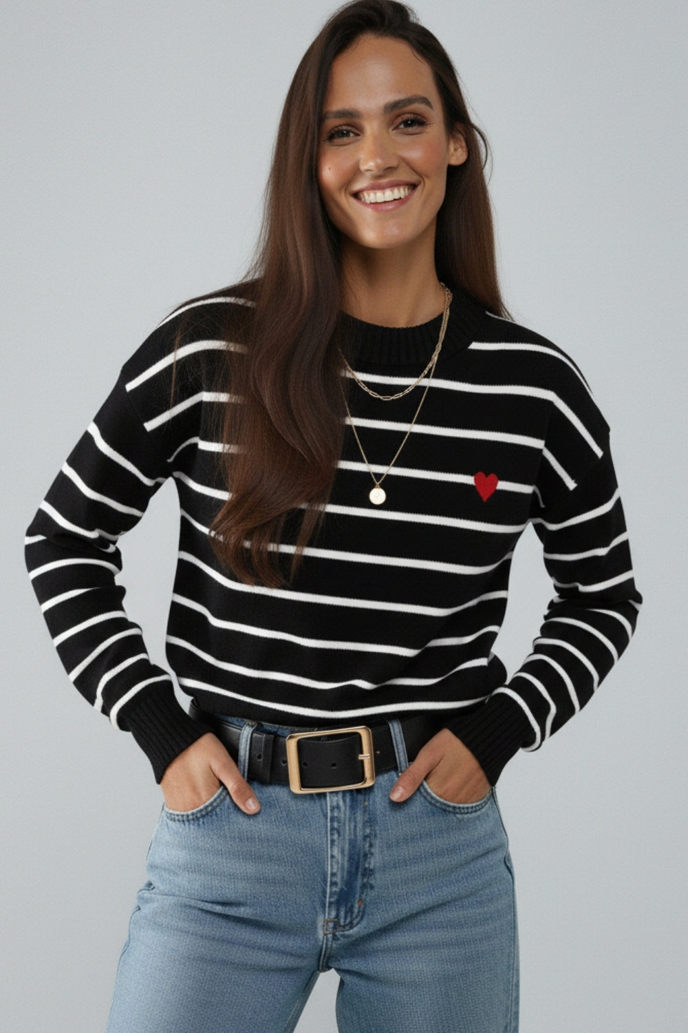 Black knit sweater with red heart detail and white striped