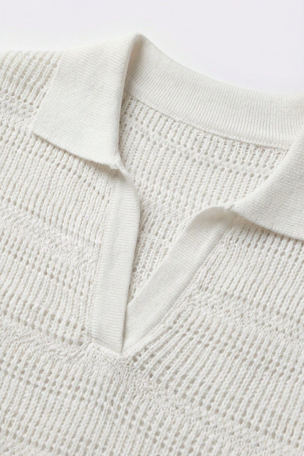 White polo shirt with short sleeves and open-knit pattern