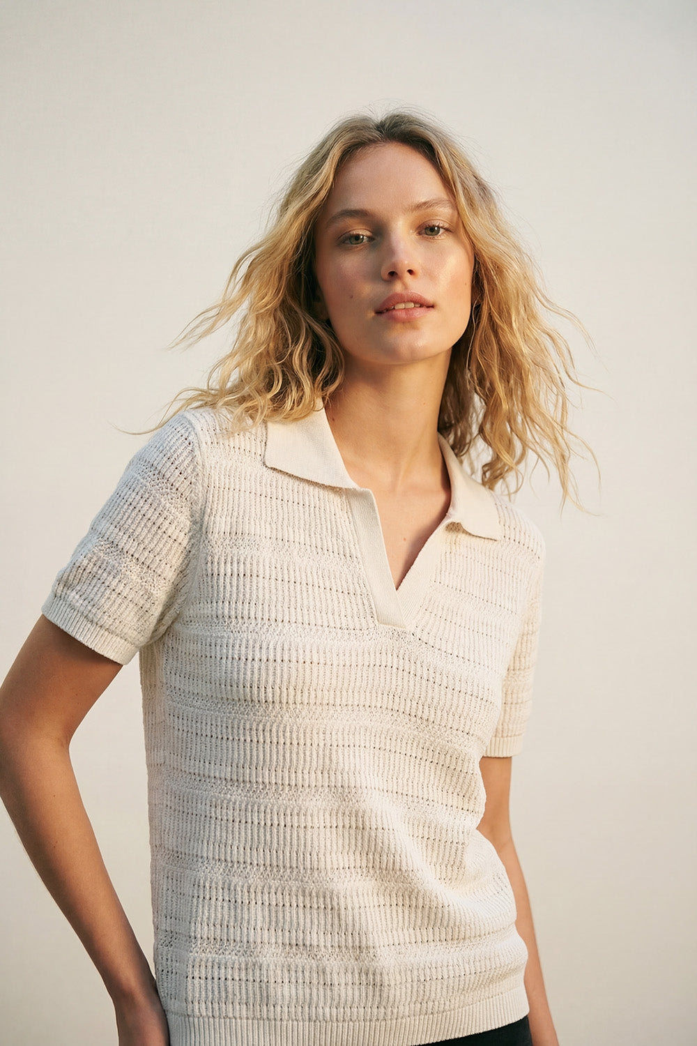 White polo shirt with short sleeves and open-knit pattern