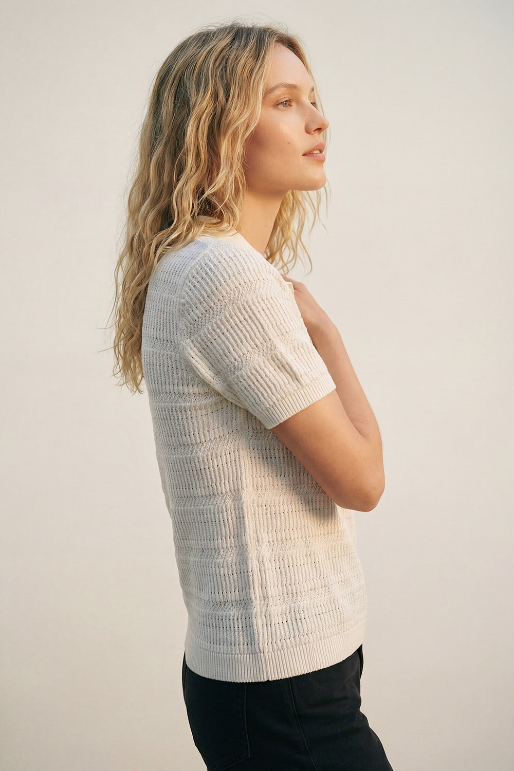White polo shirt with short sleeves and open-knit pattern