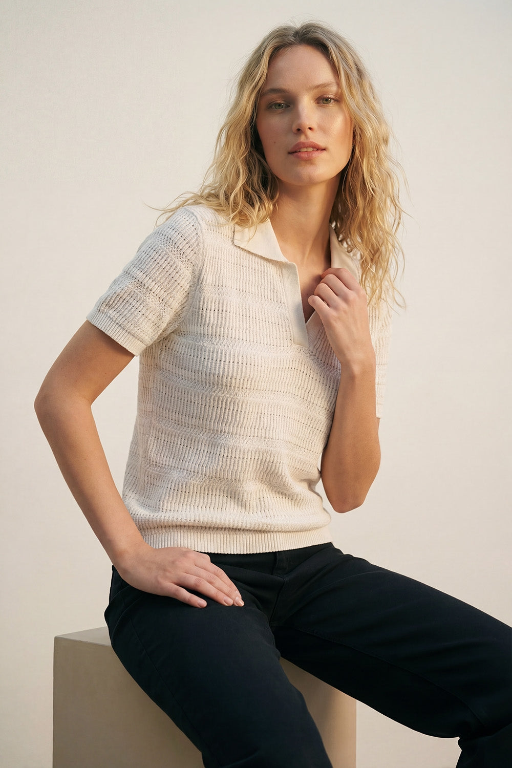 White polo shirt with short sleeves and open-knit pattern