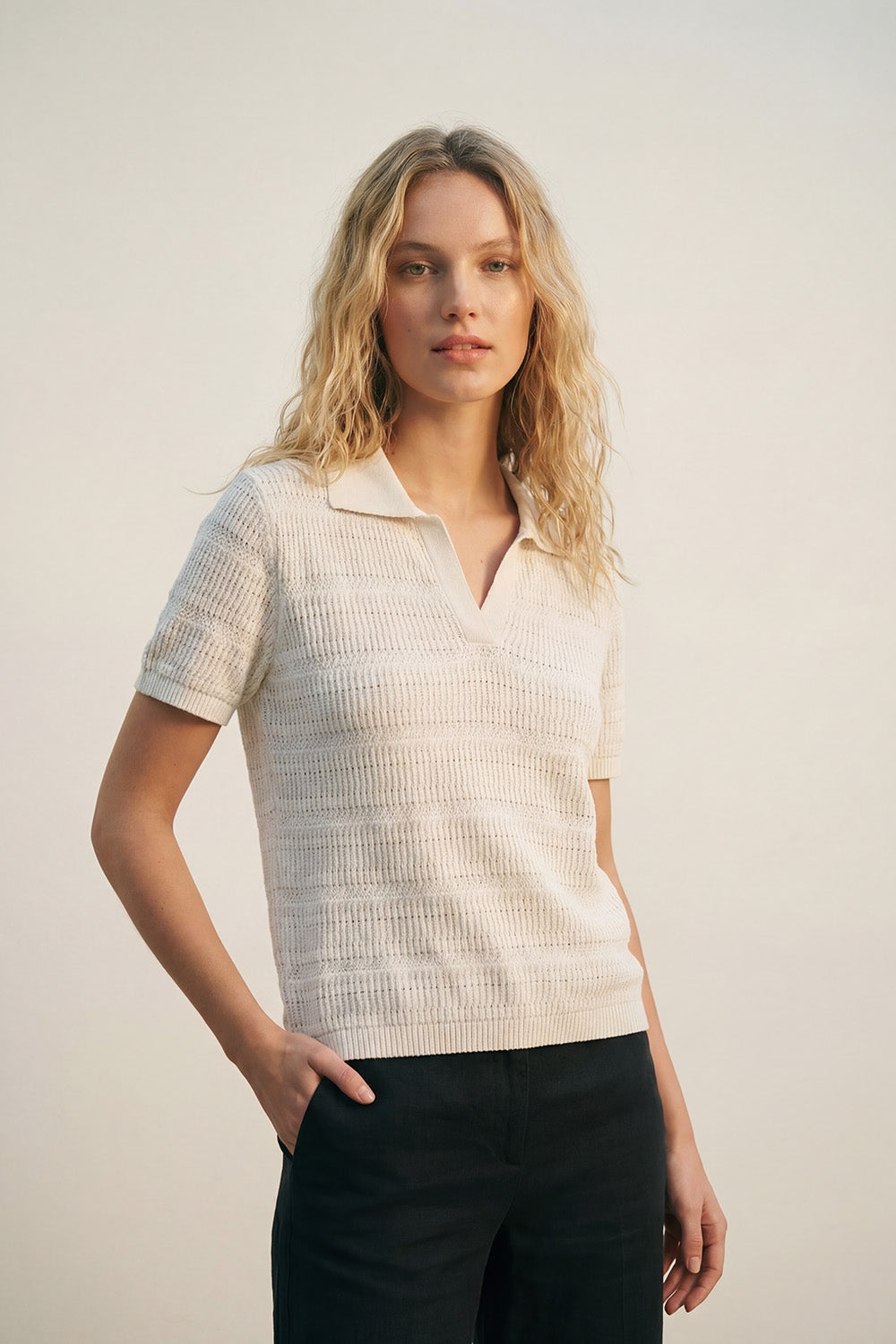 White polo shirt with short sleeves and open-knit pattern