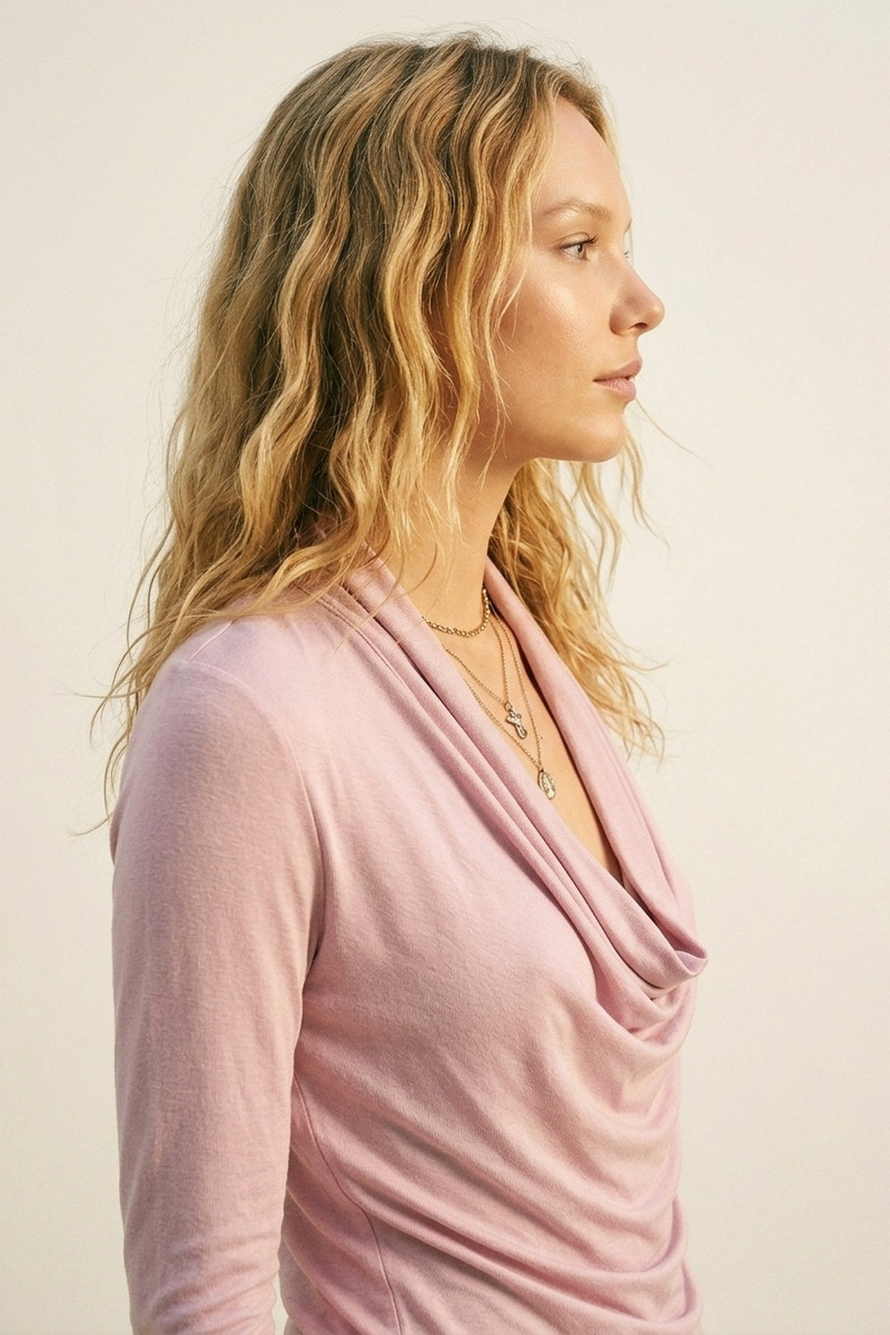 Pink three-quarter sleeve top with front draping and lightweight fabric