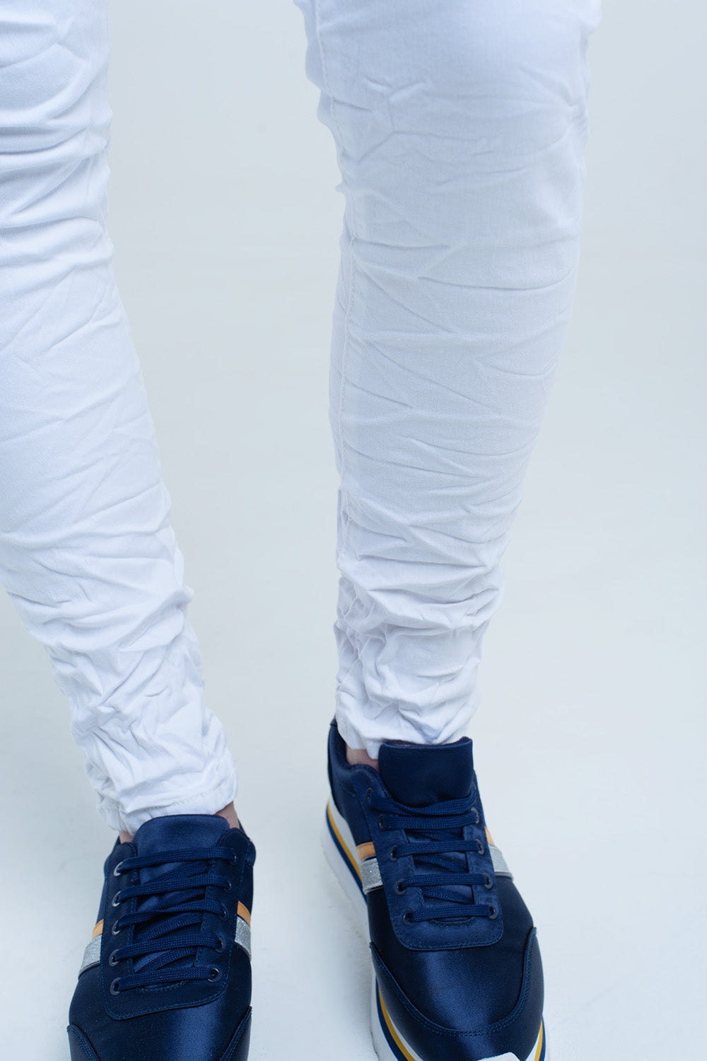 Crumpled white jeans with pockets