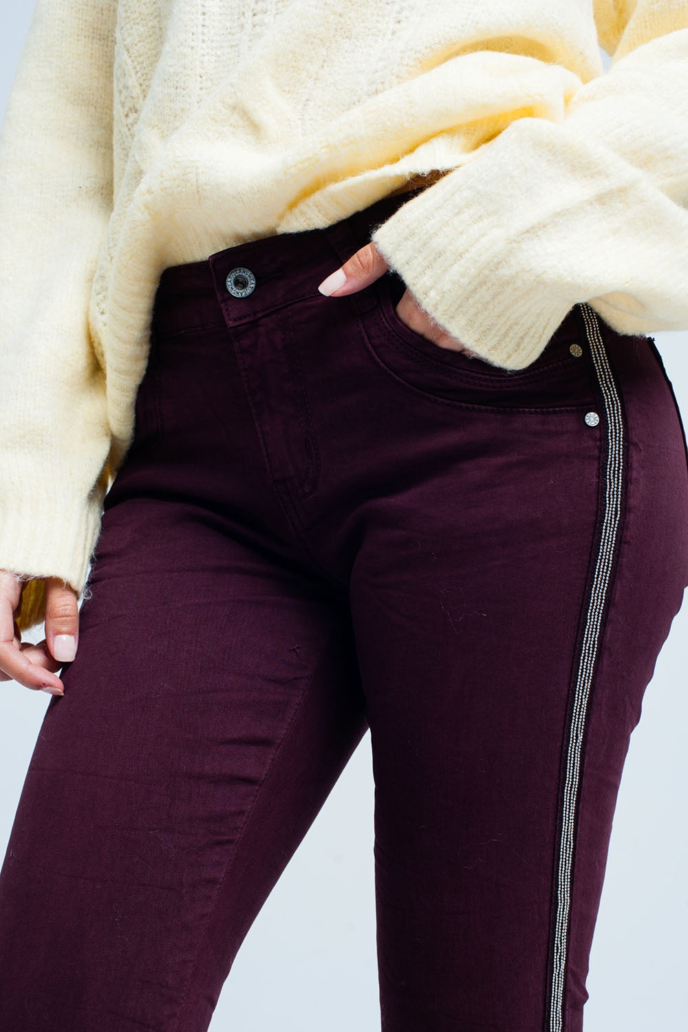 Maroon skinny jeans with metal side stripe