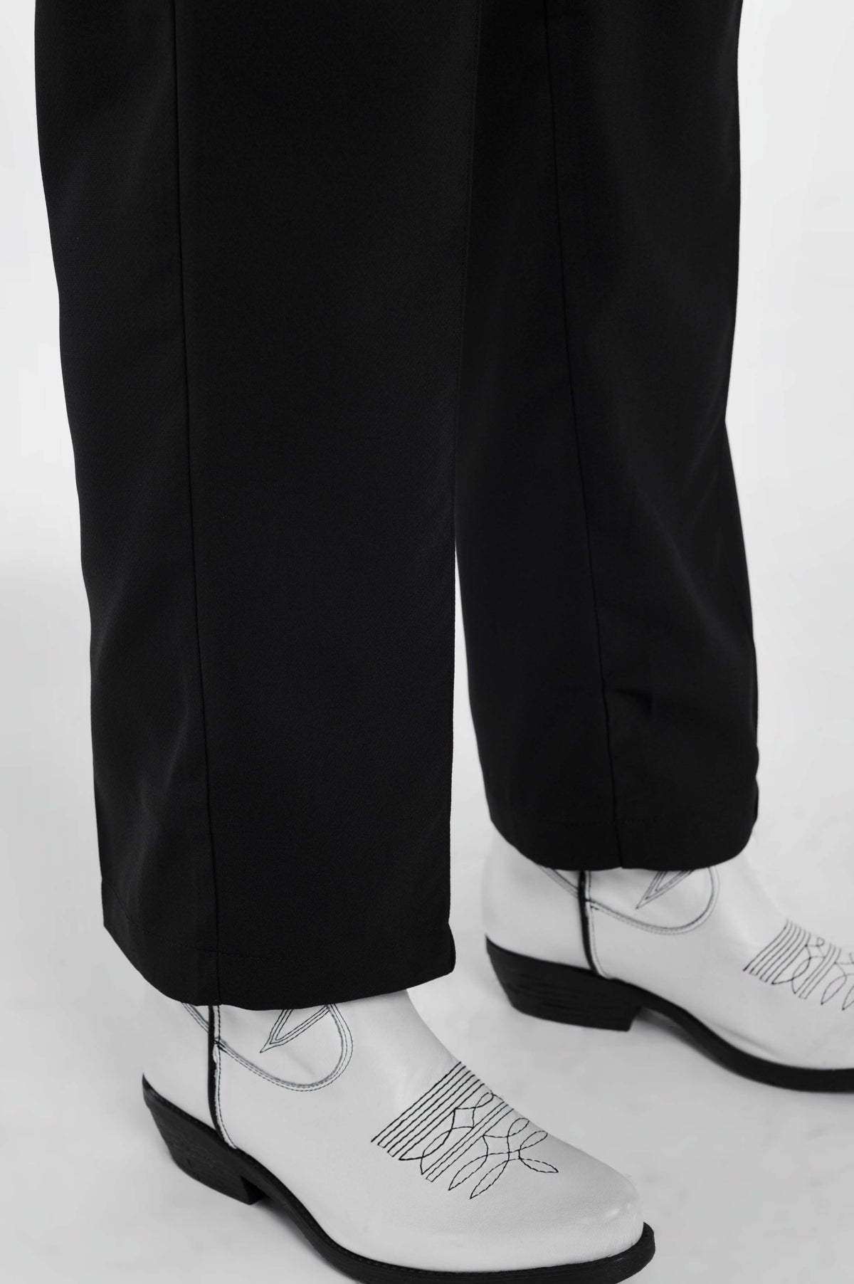 Black pants with wide legs and low hem