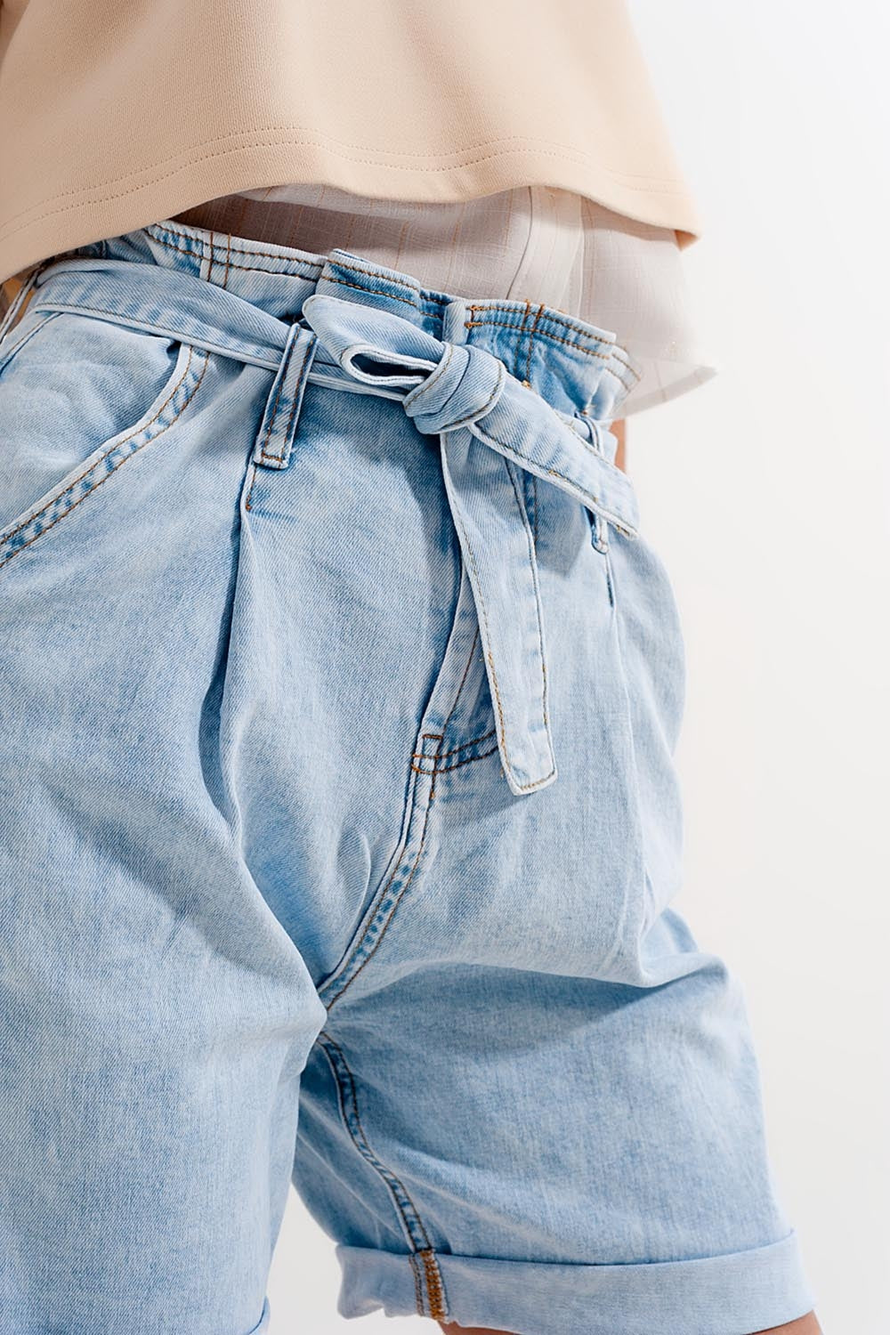 Denim shorts with light blue wash and waist tie