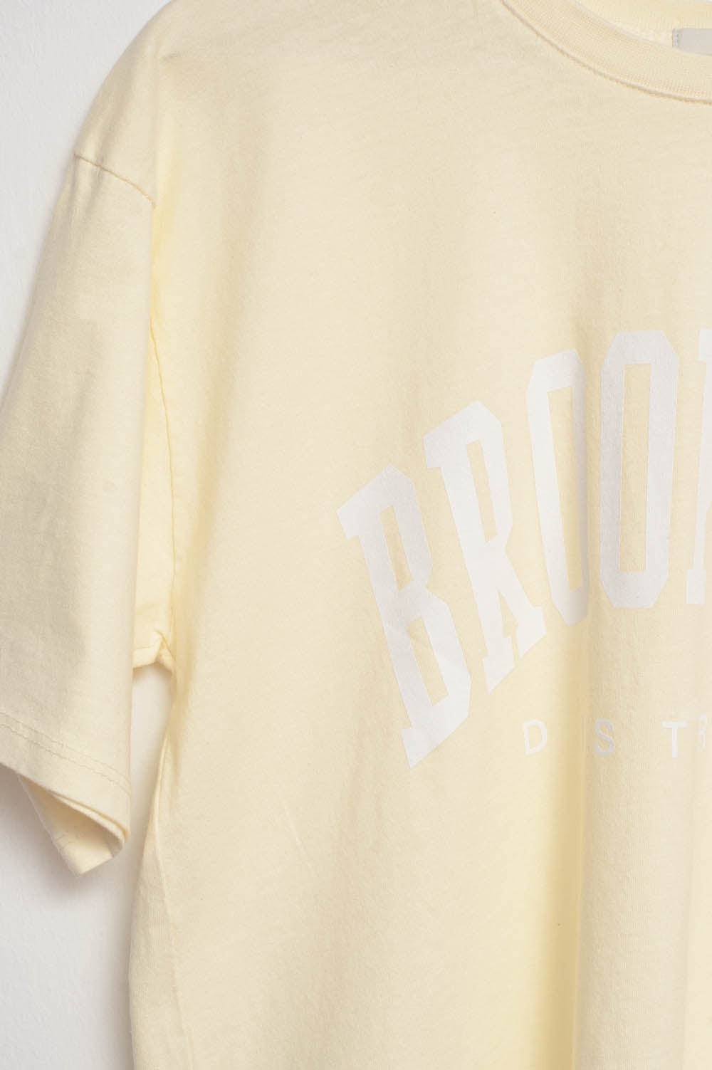 T-Shirt with Brooklyn District Text in yellow - top