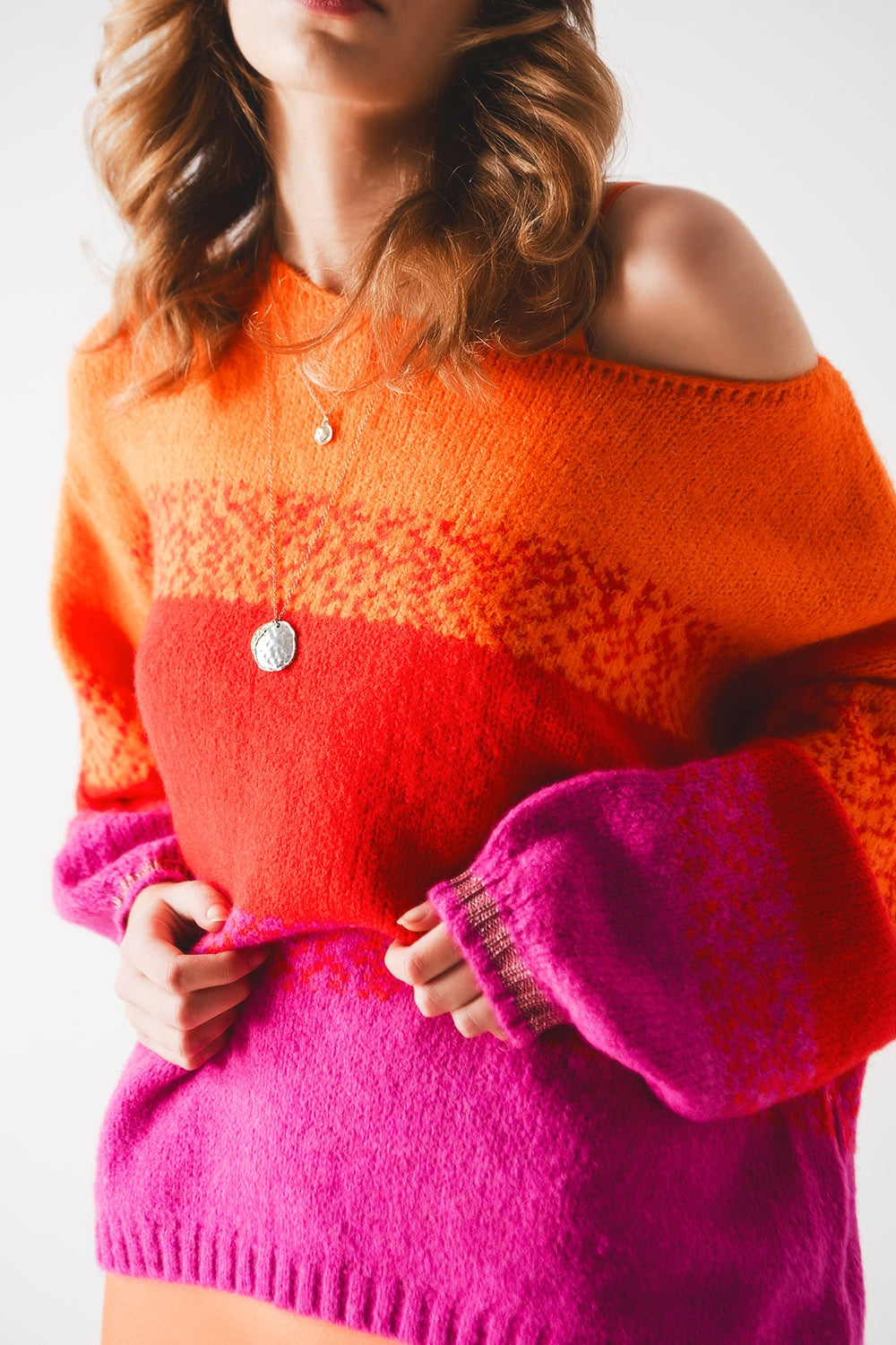 Orange knitted sweater with mélange stripes
