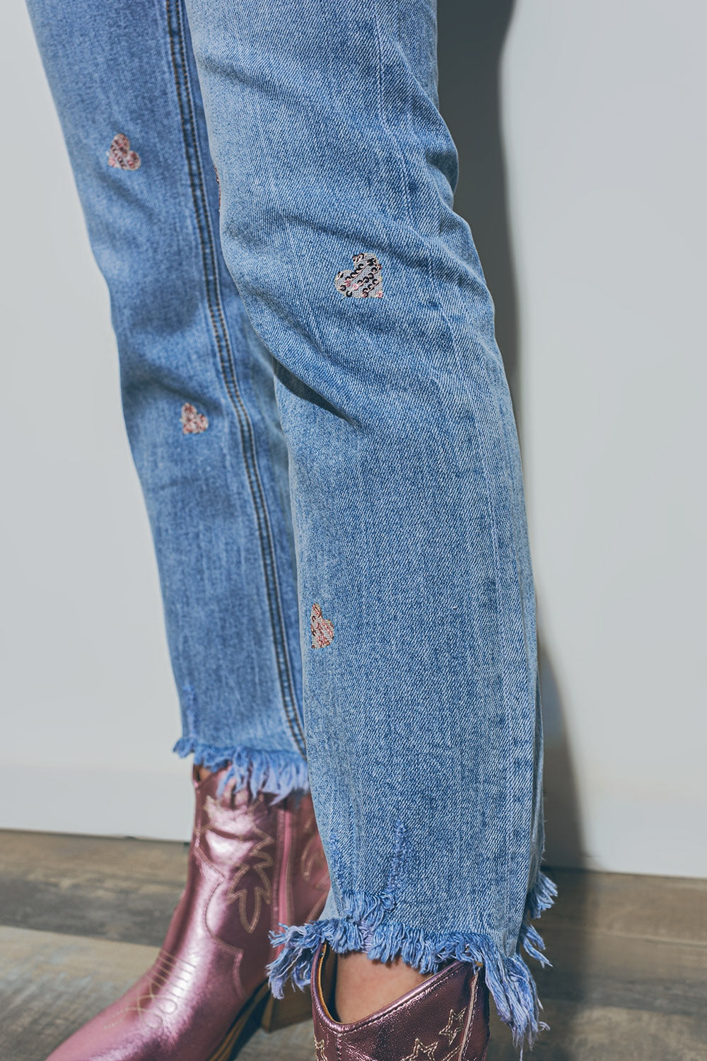 Heart Embellished Jeans with teared hem in Medium Wash - Denim