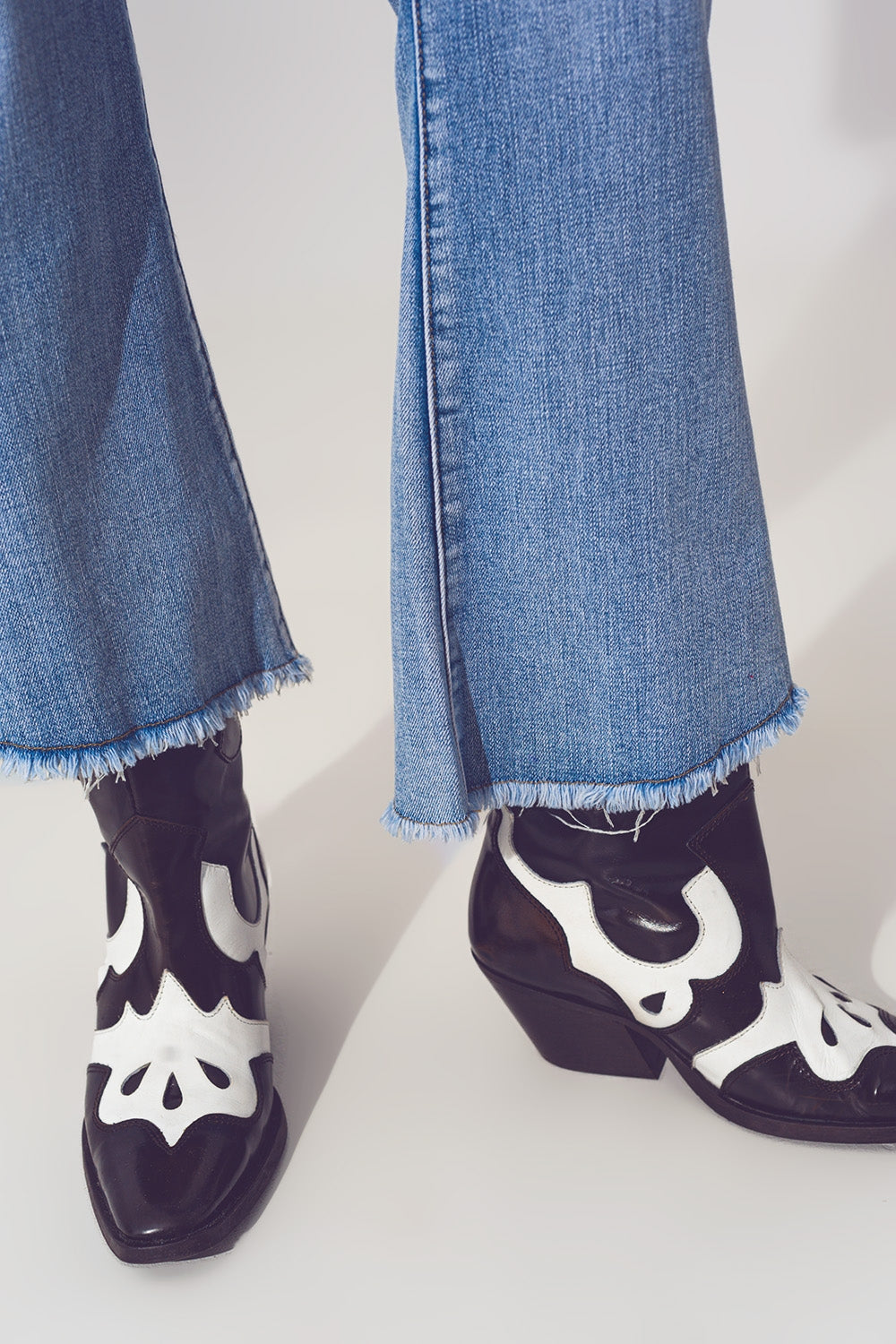 Flared Jeans in Light Blue with Asymmetric Hem - Denim
