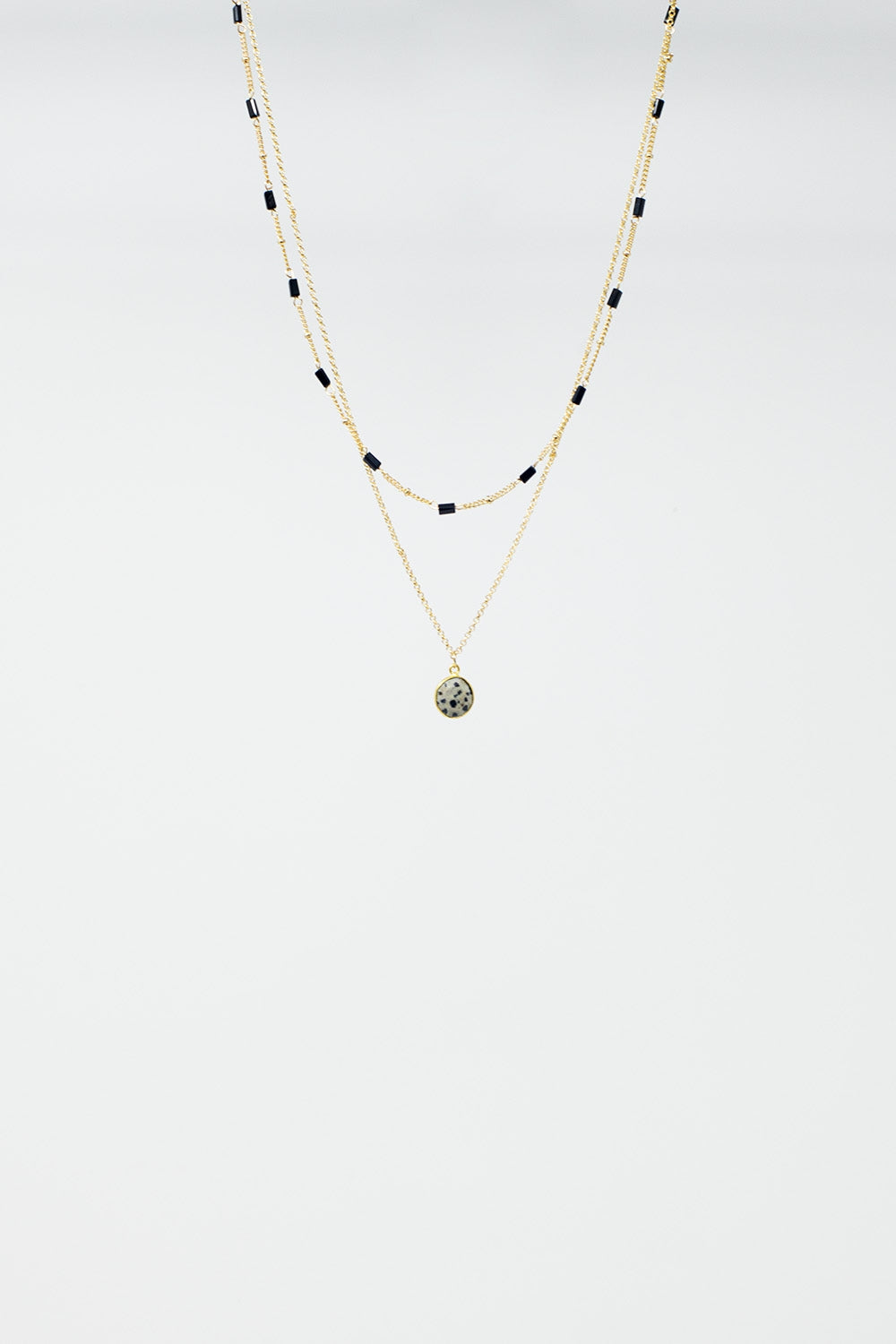 Short 2 in 1 Gold Necklace with Black Beads and White Marbled Stone.