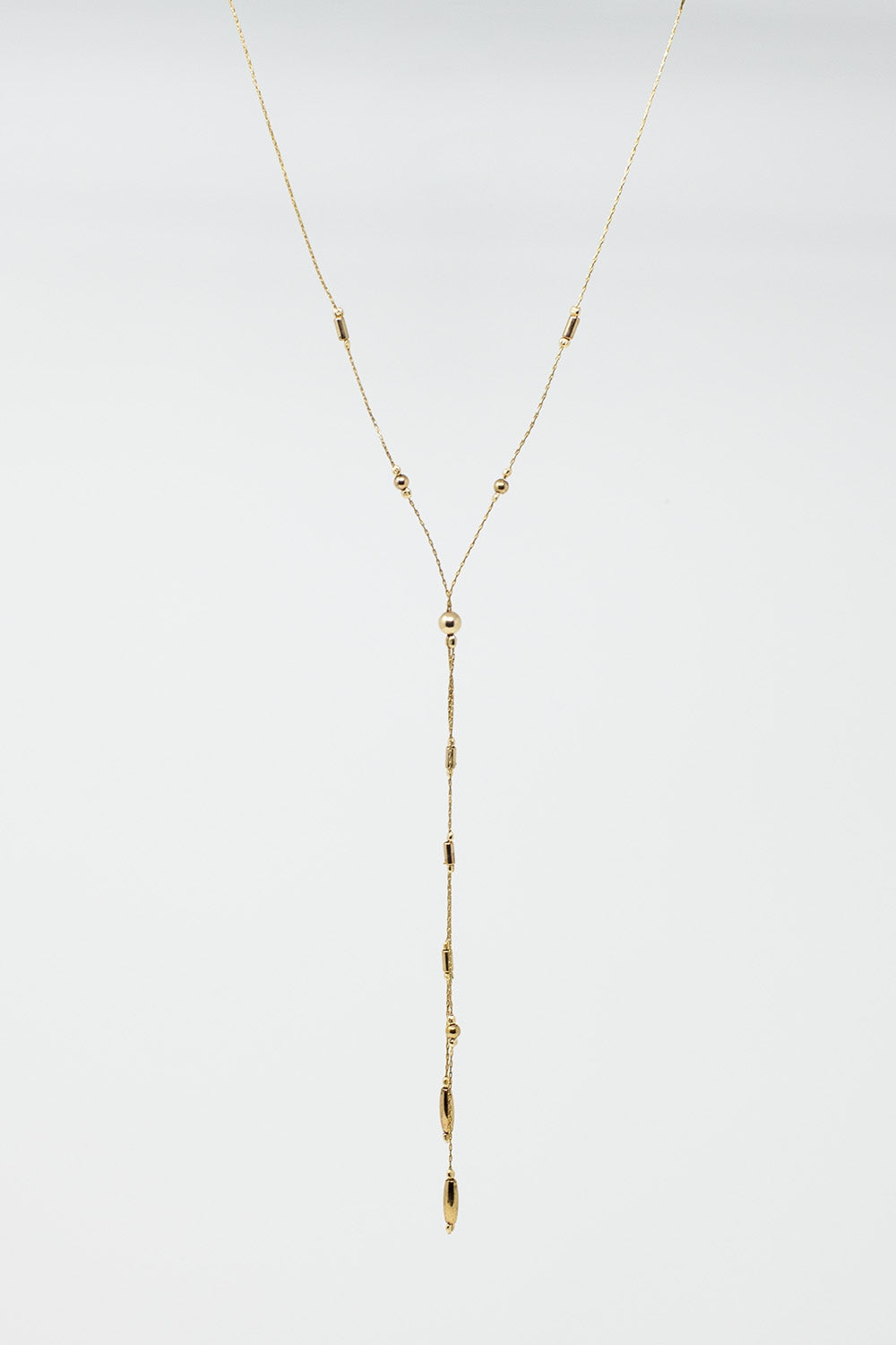 Long Gold Necklance with golden beads throughout and Long golden Tassle